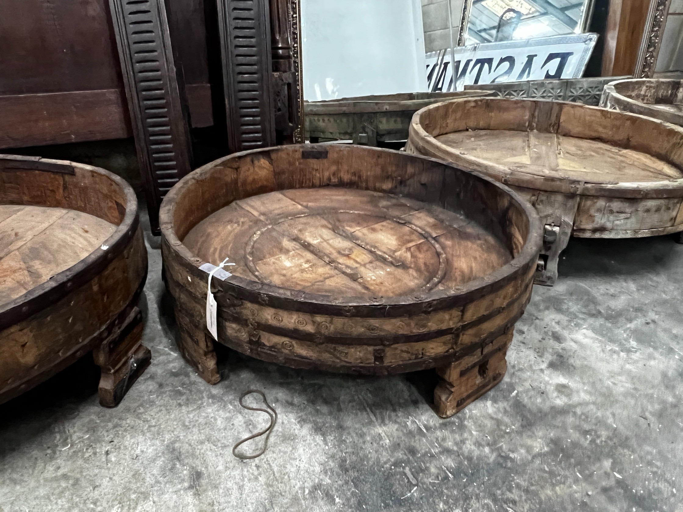 Four chip carved mazers, largest diameter 76cm, and a pair of Afghan stools